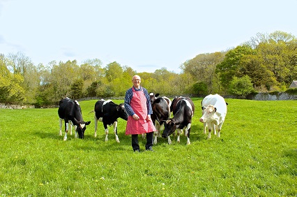 Farmer standing in field with his cattle