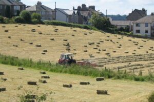 Farmer on tractor hay-baling